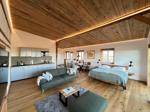 a large living room with a bed and a couch at Weinturmsruhe in Bad Windsheim