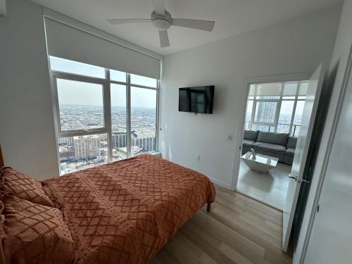 a bedroom with a bed and a large window at 2BR Panoramic City View!! in Los Angeles