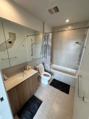 a bathroom with a toilet and a sink and a shower at 2BR Panoramic City View!! in Los Angeles