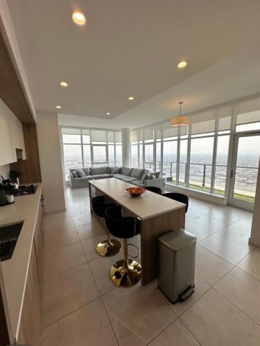 a kitchen and living room with a table and chairs at 2BR Panoramic City View!! in Los Angeles