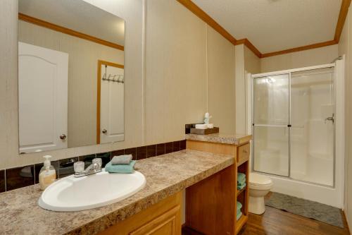 a bathroom with a white sink and a shower at Greers Ferry Lake Access Cabin with Boat Slip! in Greers Ferry