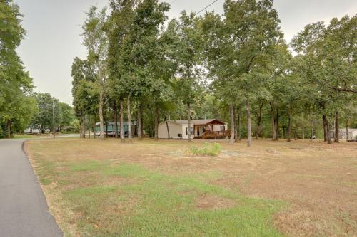 a park with a house in the distance with a yard at Greers Ferry Lake Access Cabin with Boat Slip! in Greers Ferry