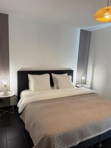 a bedroom with a large bed with white pillows at Urban Cocoon in Liège
