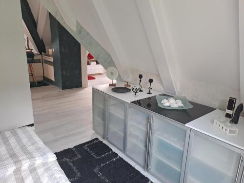a kitchen with a counter top and a staircase at DESIGN-LOFT Brockenblick in Wernigerode