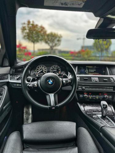 a view of the cockpit of a bmw car at BMW 535i in Tbilisi City