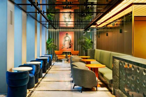 a row of tables and chairs in a restaurant at Casa Brera, a Luxury Collection Hotel, Milan in Milan