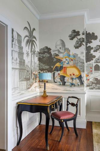 a dining room with a table and a chair at The Serangoon House Little India, Singapore, a Tribute Portfolio Hotel in Singapore