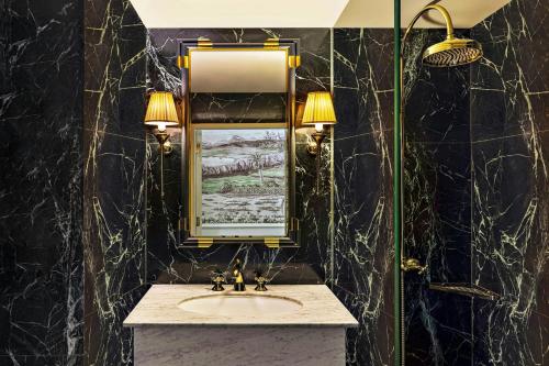 a bathroom with a sink and a mirror at The Serangoon House Little India, Singapore, a Tribute Portfolio Hotel in Singapore