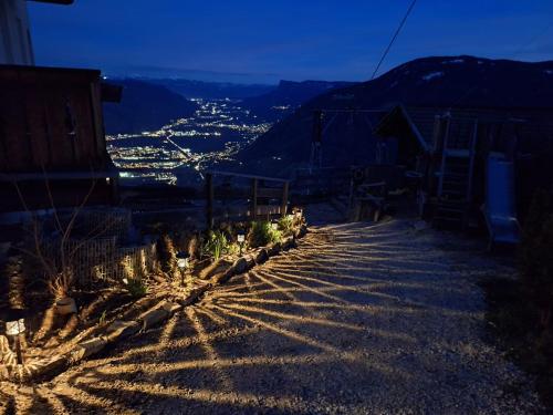 a hillside with a view of a city at night at Oberplatzer in Foresta
