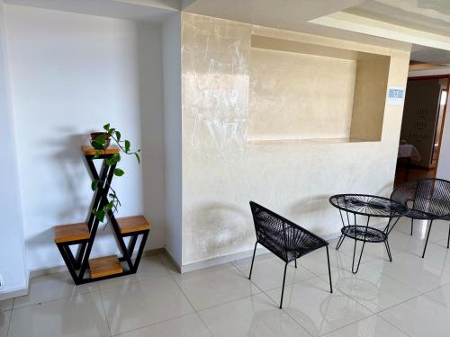 a dining room with black chairs and a table at Tiny Rooms in Toluca