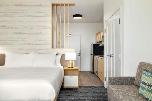 a hotel room with a bed and a couch at TownePlace Suites by Marriott Humble Intercontinental Airport in Humble