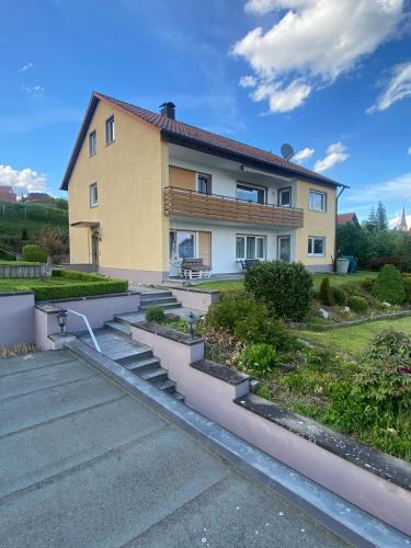 a house with stairs in front of it at Main Weindorf Unterkunft in Sulzfeld am Main