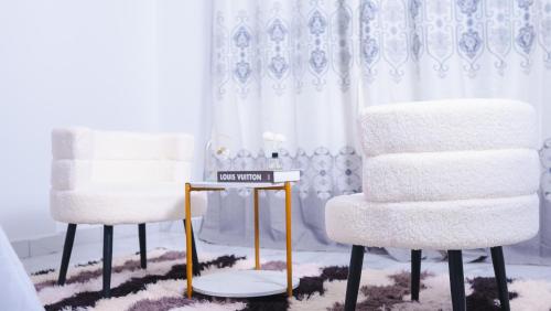 two chairs and a table in a room at Zuri Stay in Mombasa