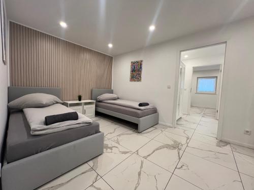 a bedroom with two beds and a mirror at Haus am Park Dreieich in Dreieich
