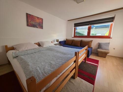 a bedroom with a large bed and a couch at Apartment near center in Sarajevo