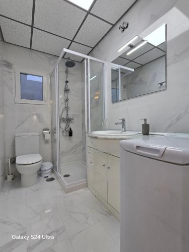 a bathroom with a shower and a toilet and a sink at BEACH Arguineguin SEA VIEW 7 CHG FAMILY HOTEL in Arguineguín