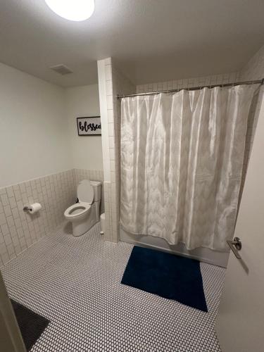 a bathroom with a toilet and a shower curtain at 1BR in Hollywood w patio & parking!! in Los Angeles