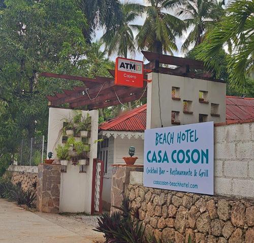a sign in front of a house with a sign at Beach Bungalow 100 m Playa Coson in Las Terrenas