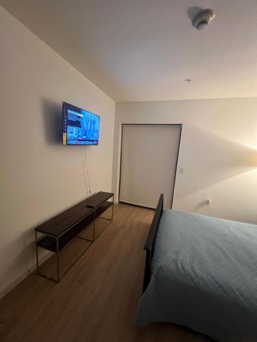a bedroom with a bed and a tv on the wall at 1BR in Hollywood w patio & parking!! in Los Angeles