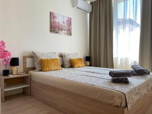 a bedroom with a large bed and a window at Barceló Apartment Velingrad in Velingrad