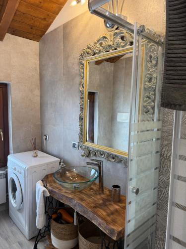 a bathroom with a sink and a washing machine at Black and White in Locate Bergamasco