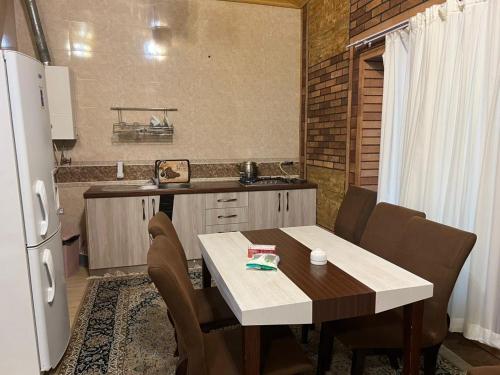 Una cocina con una mesa con sillas y un refrigerador. en Villa De Anna, en Saint-Rémy-de-Provence