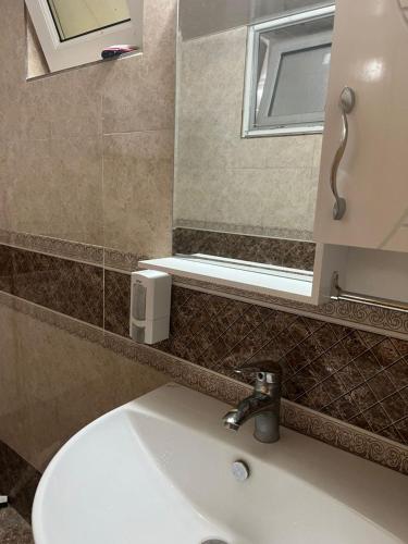 a bathroom with a white sink and a mirror at Villa De Anna in Saint-Rémy-de-Provence