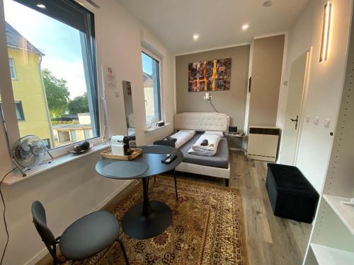 a living room with a couch and a table at Renovierte Unterkunft am Rhein in Koblenz - eigenes Bad, Küche, Wifi - 1 OG in Koblenz