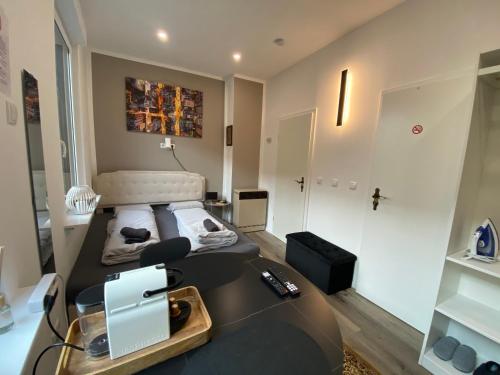 a room with a bed and a desk with a laptop at Renovierte Unterkunft am Rhein in Koblenz - eigenes Bad, Küche, Wifi - 1 OG in Koblenz