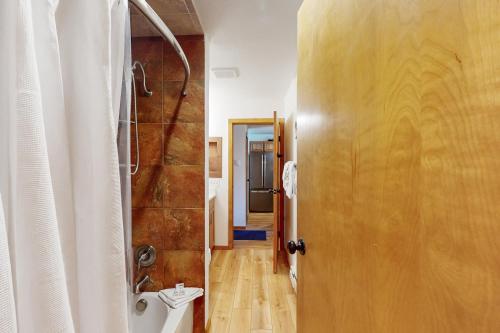 a bathroom with a shower and a toilet next to a door at Marina Place 137 in Dillon