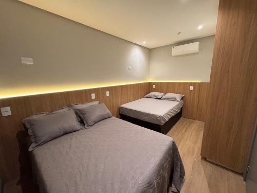 a hotel room with two beds in a room at Flats New York in Itapema