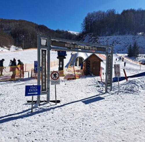 a sign in the snow in front of a ski slope at Apartment Aleksandar AS in Brzeće