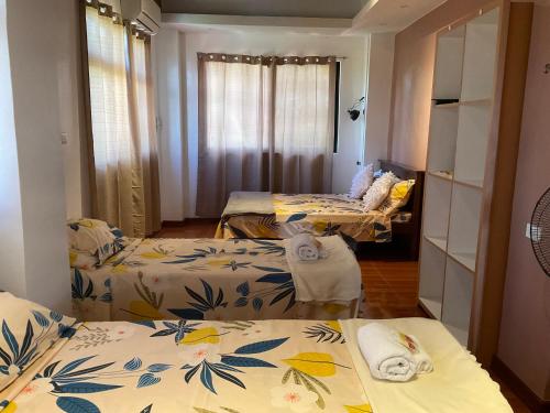 a room with two beds and a mirror at THE-SOMERSET INN & RESTAURANT in Iloilo City