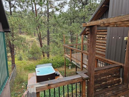 a grill sitting on the deck of a cabin at cabin in the woods with Hottub in Billings