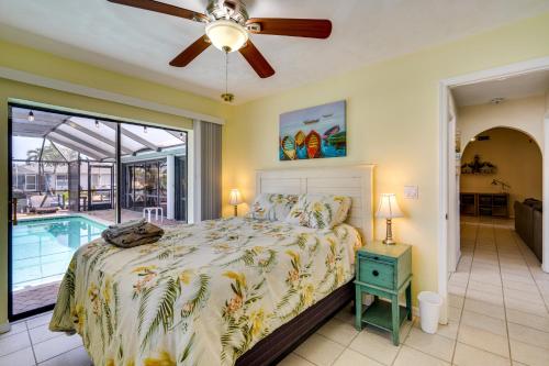 a bedroom with a bed and a swimming pool at Canal-Front Gem with Lanai and Dock in Cape Coral in Cape Coral Hospital Heliport