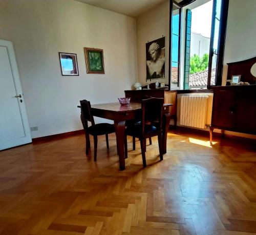 a dining room with a wooden table and chairs at Residence Armellini in Lido