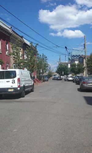 a street with cars parked on the side of the road at New York Homestay in Newark