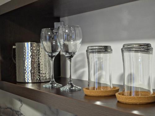 four empty wine glasses sitting on a shelf at Guest House Marli in Ohrid