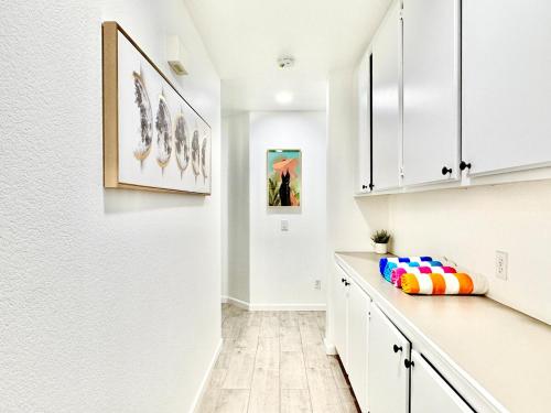 a kitchen with white cabinets and a counter with a pillow at Coachella Private Pool Fire Pit BBQ with Chefs Kitchen in Indio