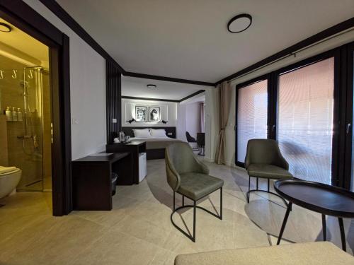 a hotel room with a bed and a table and chairs at Guest House Marli in Ohrid