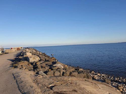 a group of rocks on the shore of a body of water at 6 person holiday home in Vesløs-By Traum in Øsløs