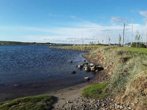 a river with rocks in the water with boats at 7 person holiday home in Højslev-By Traum in Højslev