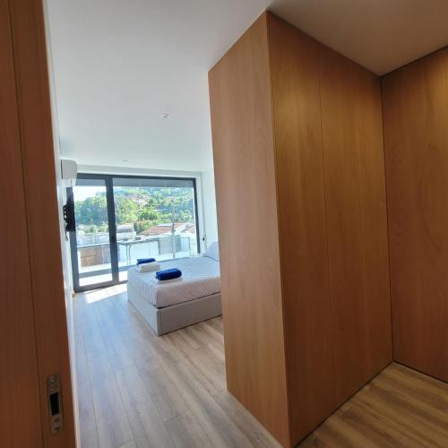 a bedroom with a bed and a large wooden wall at Casa da Praia - Gerês in Bicas