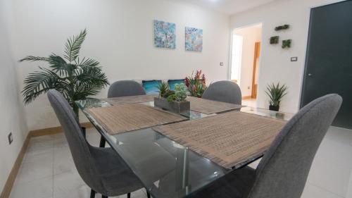 a dining room with a glass table and chairs at Hotel La Mariposa in Manuel Antonio
