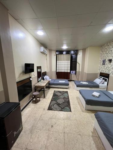 a room with beds and a fireplace and a tv at One Season Hotel in Cairo