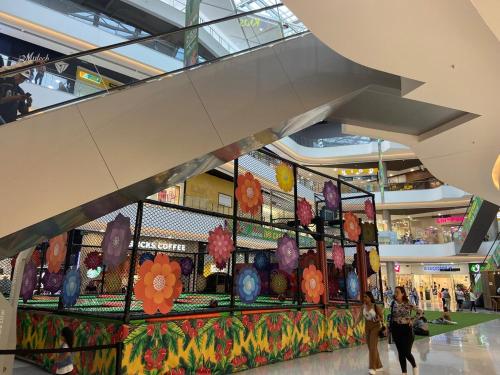 a display in a shopping mall with people walking in it at Magical stay in the pink area of Bello in Bello