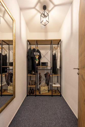 a dressing room with a mirror and a closet at Hotel Residenz Luxury - Outletcity - Parken - Klima - 24h Check-In in Metzingen