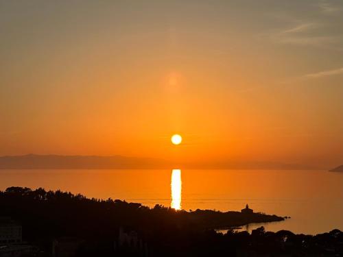 a sunset over a body of water at Luxury Adria Sea City & Whirpool, Mountain View Apartment in Makarska