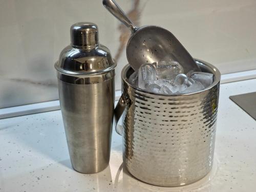 a metal container with a bottle of water in it at Guest House Marli in Ohrid
