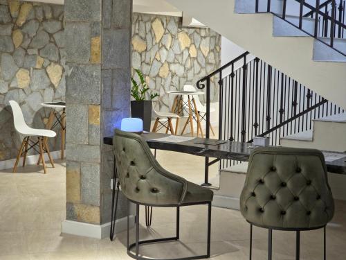 a dining room with a table and two chairs at Guest House Marli in Ohrid